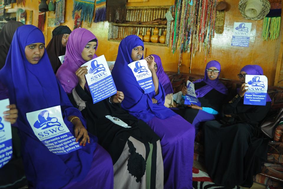 Somali female activists, holding messages&nbsp;that read "Save Somali Women and children," gather to mark International Women's Day.