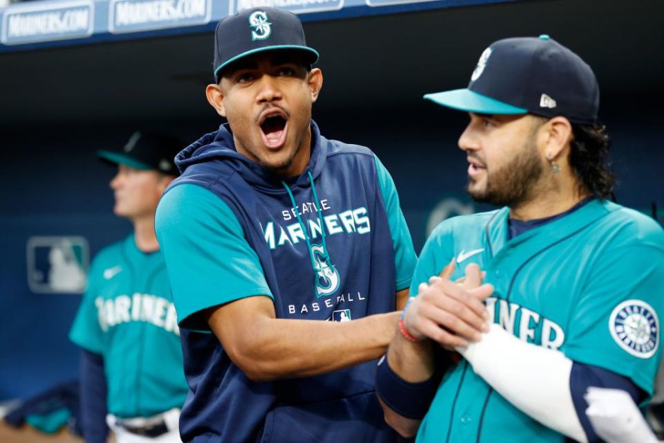 SEATTLE, WASHINGTON - SEPTEMBER 30: Julio Rodriguez #44 and Eugenio Suarez #28 of the Seattle Mariners joke before the game against the Oakland Athletics at T-Mobile Park on September 30, 2022 in Seattle, Washington. (Photo by Steph Chambers/Getty Images)