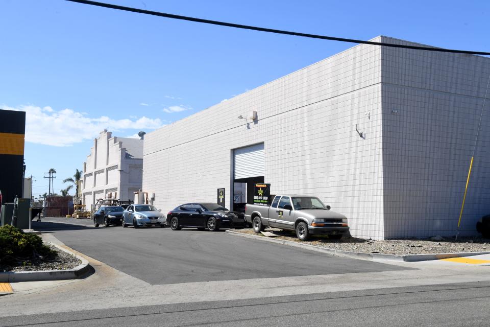 A short alley leads to the rear parking area of a local auto body shop on Industrial Avenue in Oxnard on Tuesday, March 19, where an Oxnard woman was found with a fatal gunshot wound late Sunday.