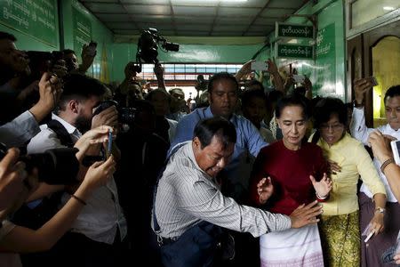 Myanmar's National League for Democracy (NLD) party leader Aung San Suu Kyi reacts as some cameramen fell to the floor, before casting her ballot during the general election in Yangon, in this November 8, 2015 file photo. REUTERS/Jorge Silva/Files
