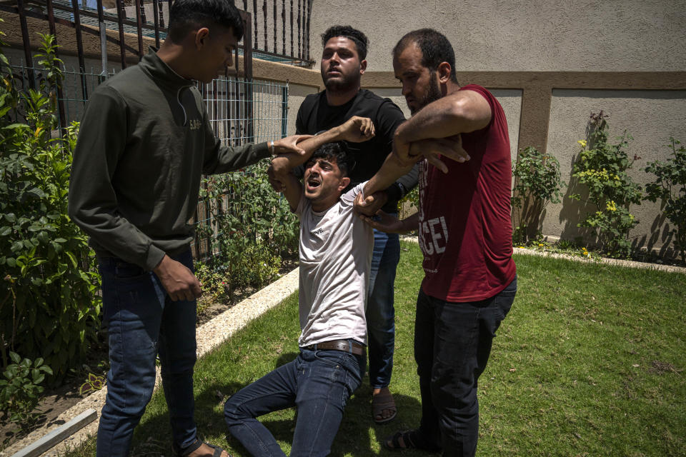 Palestinians mourn for Mohammed Abu Taima, killed in an Israeli airstrike, in Khan Younis in the Gaza Strip, Wednesday, May 10, 2023. Israeli authorities say Palestinian militants in the Gaza Strip have launched rockets toward southern Israel. Wednesday's launch comes a day after Israeli airstrikes killed three militant leaders and at least 10 civilians. (AP Photo/Fatima Shbair)