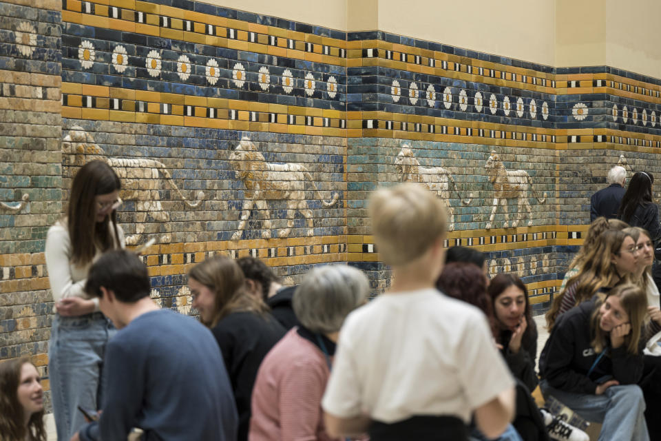 Visitors in front of Processional Way of Babylon at Pergamon Museum in Berlin, Tuesday, April 4, 2023. A new light and sound installation by British contemporary artist Liam Gillick, part of the show Filtered Time, opened Tuesday at one of the German capital's most popular museums. (AP Photo/Stefanie Loos)