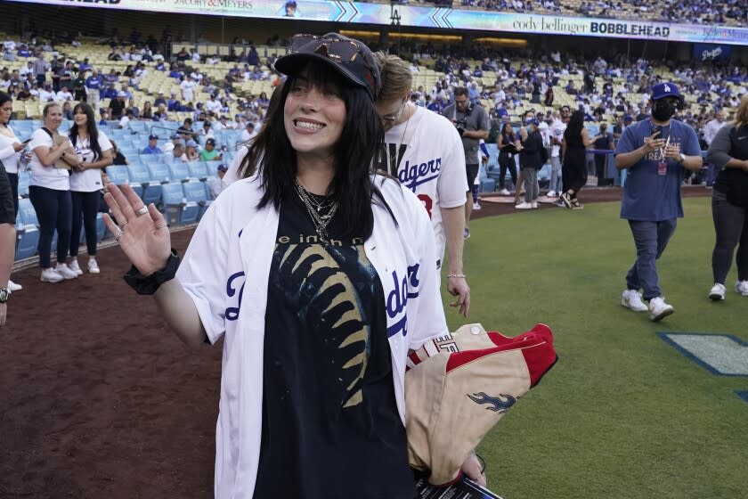 Singer Billie Eilish waves to fans at Dodger Stadium on July 21, 2022, in Los Angeles.