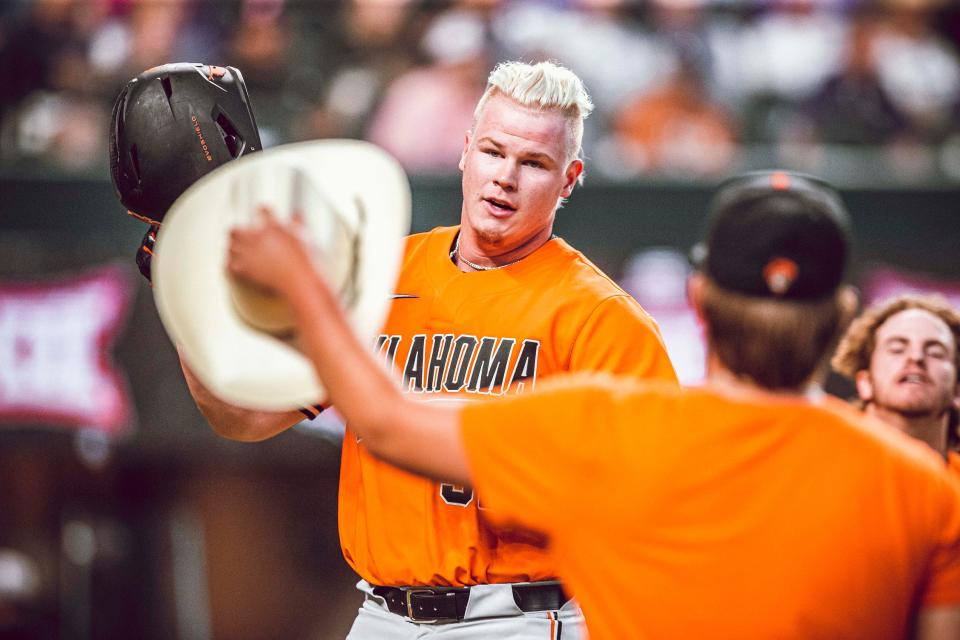 OSU designated hitter Griffin Doersching (52) awaits receiving a cowboy hat after hitting a home run Friday in an 8-4 win against TCU.