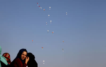 FILE PHOTO: Balloons are seen flying over the Israel-Gaza border during a protest in the southern Gaza Strip July 6, 2018. REUTERS/Ibraheem Abu Mustafa