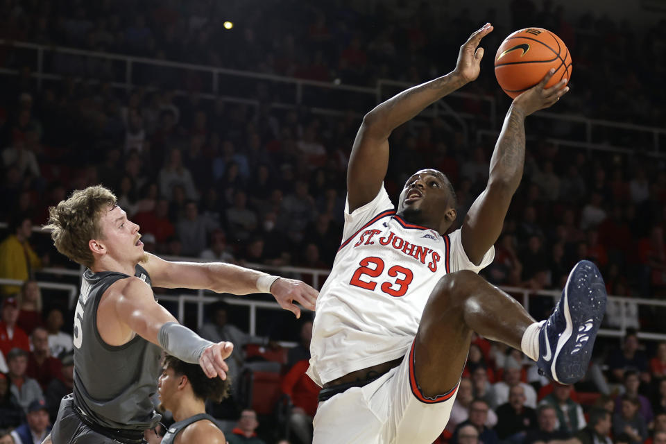 St. John's forward David Jones (23) shoots over Xavier guard Adam Kunkel during the second half of an NCAA college basketball game Wednesday, Dec. 28, 2022, in New York. Xavier won 84-79. (AP Photo/Adam Hunger)