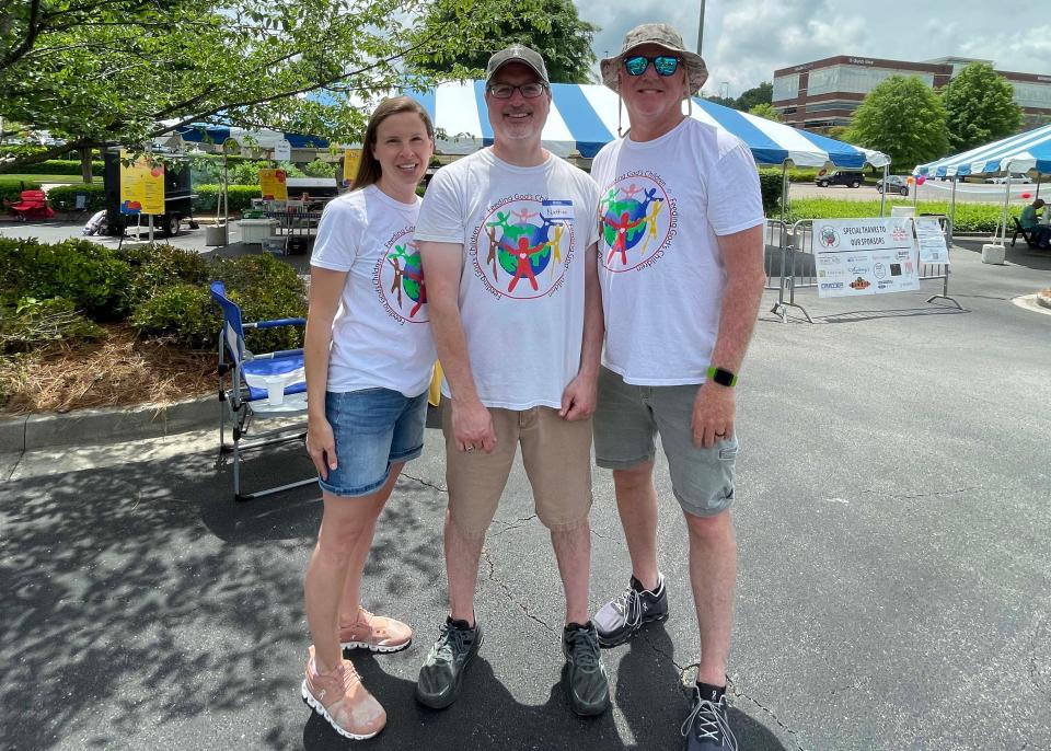 Samantha Williams, executive assistant, with Nathan Kluemper, board president, and Jim Mauck, board member for Feeding God’s Children, a nonprofit that serves children in Appalachia and Guatemala.