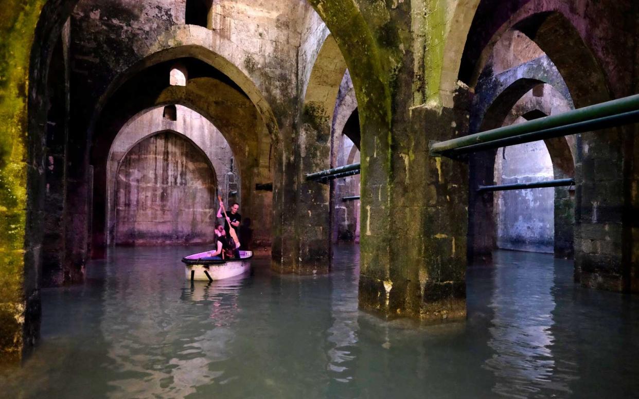 Visitors boating inside the Pool of Arches also known as St. Helen's pool an underground water cictern built in 789 AD in the city of Ramle or Ramla in Israel