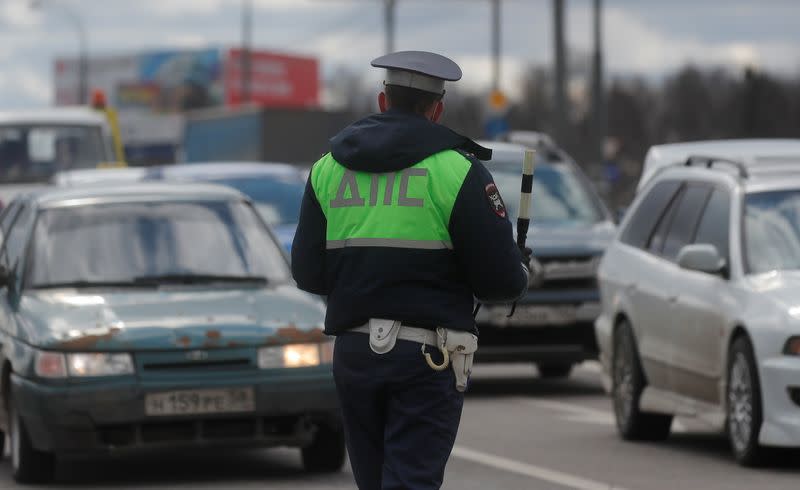A traffic police officer checks cars on the outskirts of Moscow