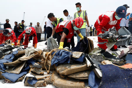 Rescue workers pick up recovered debris of Lion Air flight JT610 to load onto a truck at Tanjung Priok port in Jakarta, Indonesia, November 2, 2018. REUTERS/Edgar Su