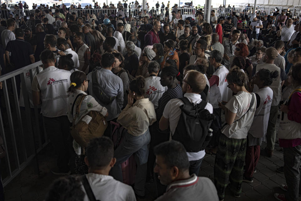 Palestinians and foreign aid workers wait to cross into Egypt at Rafah, Gaza Strip, on Wednesday, Nov. 1, 2023. (AP Photo/Fatima Shbair)