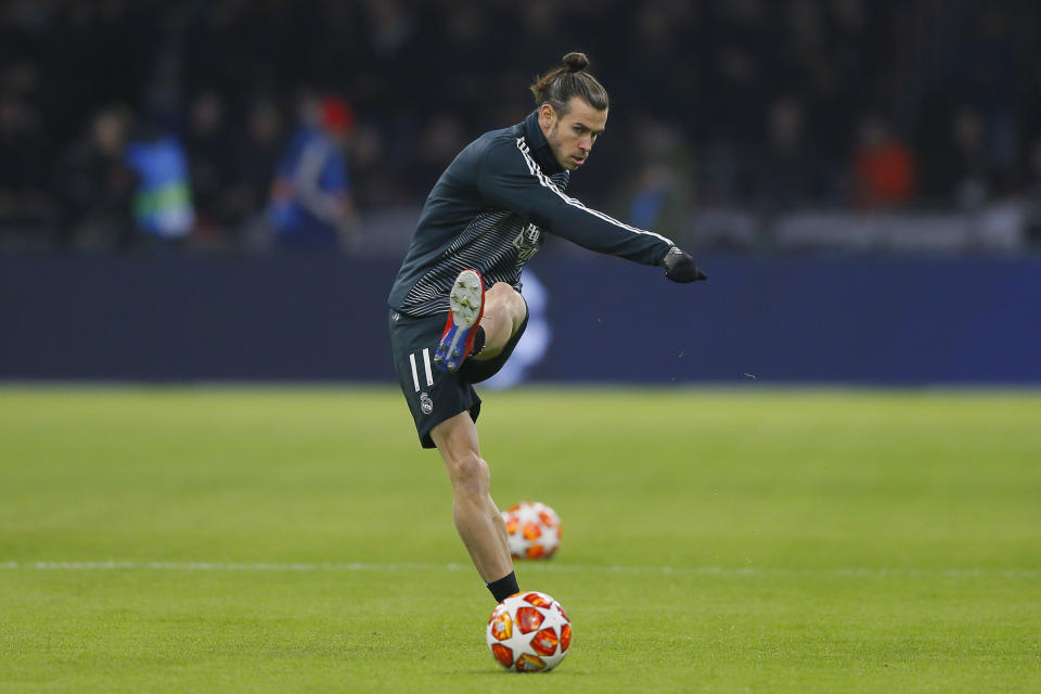 Real midfielder Gareth Bale shoots the ball as warming up during the first leg, round of sixteen, Champions League soccer match between Ajax and Real Madrid at the Johan Cruyff ArenA in Amsterdam, Netherlands, Wednesday Feb. 13, 2019. (AP Photo/Peter Dejong)