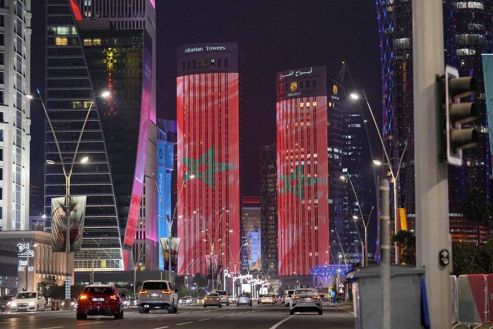 The Morocco flag is projected on tower blocks in the city center of Doha, Qatar, after Morocco won the World Cup round of 16 soccer match between Morocco and Spain, at the Education City Stadium, Tuesday, Dec. 6, 2022. (AP Photo/Martin Meissner)