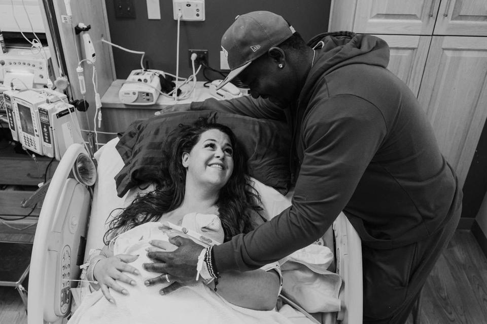 <p>Amber Hoskins</p> Emily and Kobe with their baby boy