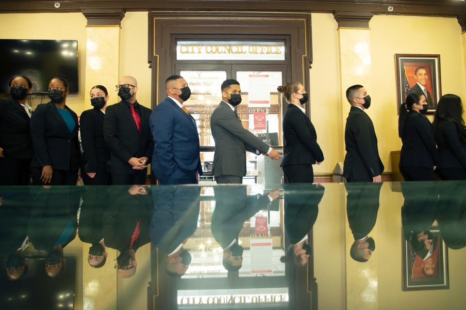 Twenty-three recruits line up outside of the City Council Cambers before waling in to be sworn in to begin six months of police academy before becoming Paterson Police Officers at City Hall in on Monday Jan. 31, 2022. 