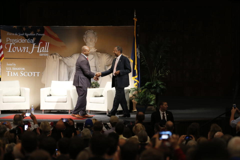 Carson takes the stage, greeted by Scott