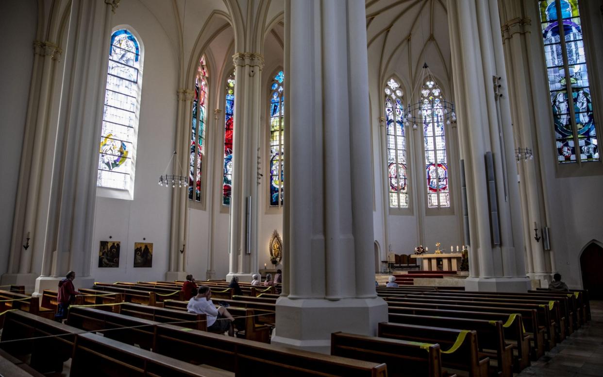 Mandatory Credit: Photo by OMER MESSINGER/EPA-EFE/Shutterstock (10611040e) Worshippers keep distance as they pray during Easter day at the St. Matthias Catholic church in Berlin, Germany, 12 April 2020. In order to comply with the 'Social distancing' restrictions and to balance worshippers health-safety and the freedom of religion, church-goers were to remain in a 4 meter distance from each other, as every second row of benches were blocked for sitting, in addition religious articles and ornaments were not to be touched. The German government and local authorities are heightening measures to stem the spread of the coronavirus SARS-CoV-2 which causes the COVID-19 disease. Easter Sunday mass in Berlin, Germany - 12 Apr 2020 - OMER MESSINGER/EPA-EFE/Shutterstock