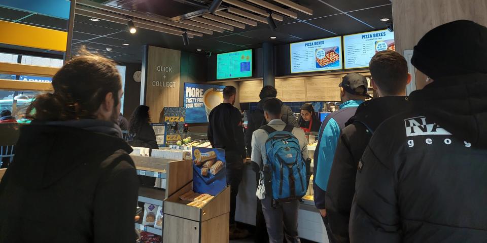 Queue of customers inside a Greggs store in London