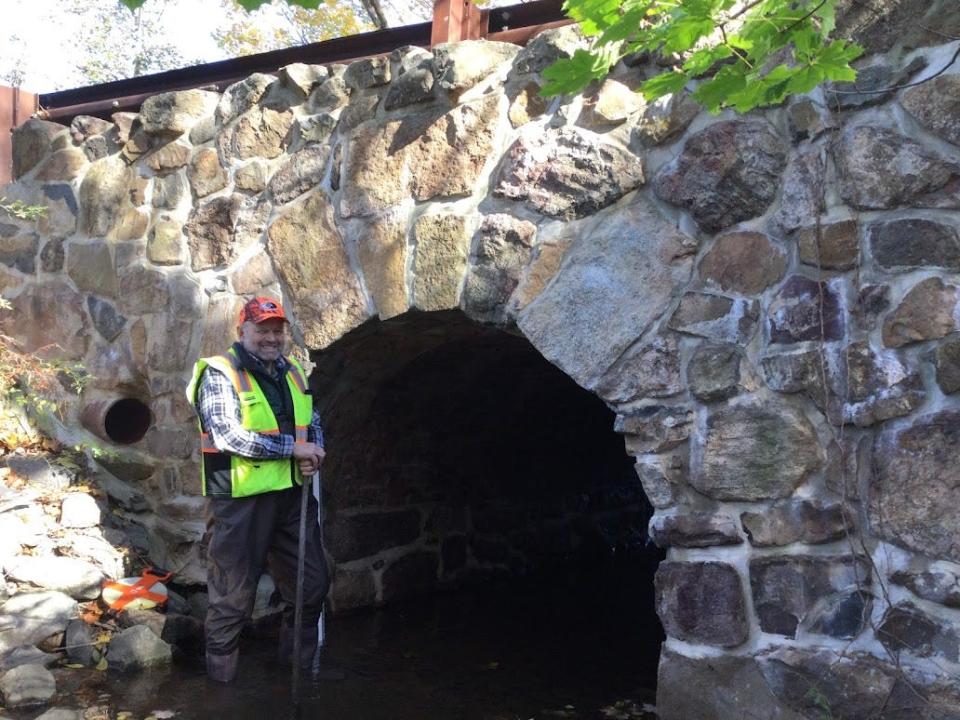 Ray Croot, a trained volunteer for Raritan Headwaters, assesses a culvert.