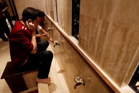 A Muslim worker cleans himself before prayers at the Al Meroz hotel in Bangkok, Thailand, August 29, 2016. REUTERS/Chaiwat Subprasom