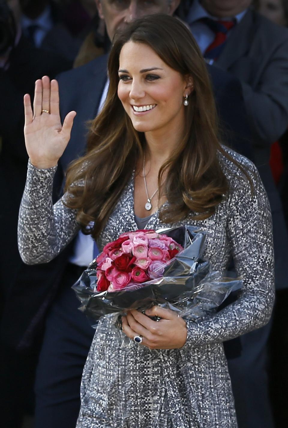 FILE - In this Tuesday, Feb. 19, 2013 file photo Britain's Kate, The Duchess of Cambridge waves as she leaves after a visit to Hope House, in London. It was announced on Monday, July 22, 2013, in London that Kate, Duchess of Cambridge and her husband Prince William, the Duke of Cambridge, gave birth to a boy weighting 8lbs 6 oz. (AP Photo/Kirsty Wigglesworth, File)