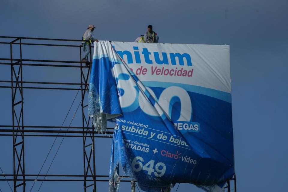 Workers remove a billboard advertisement ahead of Hurricane Beryl in Playa del Carmen, Mexico on July 3 (Copyright 2024 The Associated Press. All rights reserved)