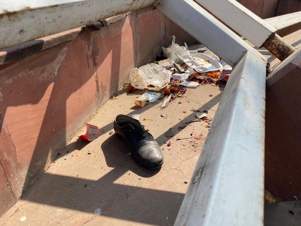 A single shoe lies amid litter at Red Fort, a day after clashes between police and protesters.