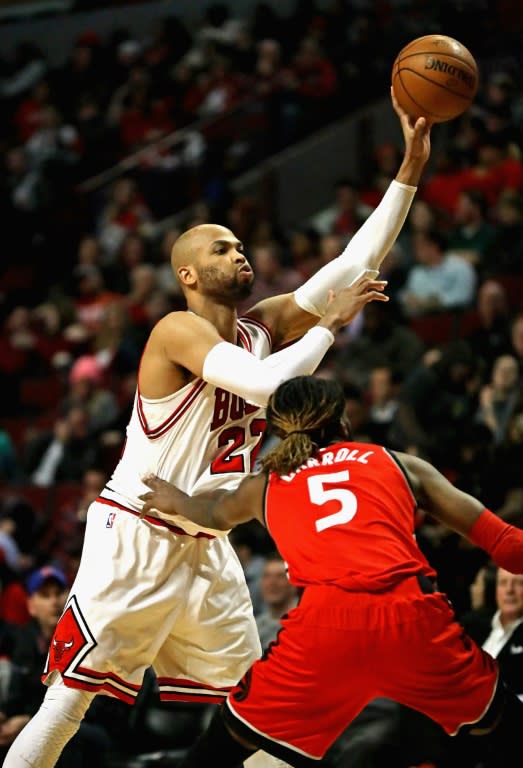 Taj Gibson of the Chicago Bulls passes over DeMarre Carroll of the Toronto Raptors during their NBA game at the United Center in Chicago, Illinois, on February 14, 2017