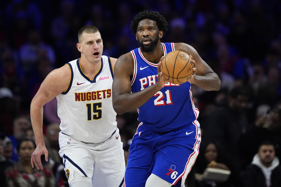 Philadelphia 76ers' Joel Embiid, right, tries to keep away from Denver Nuggets' Nikola Jokic during the first half of an NBA basketball game, Tuesday, Jan. 16, 2024, in Philadelphia. (AP Photo/Matt Slocum)