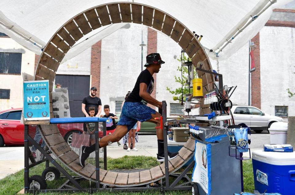 Raheem Fielder-Bey of Kansas City powers a hamster wheel to make his snow cone at Kansas City’s Juneteenth Heritage Festival in the 18th and Vine Jazz District Saturday, June 19, 2021.