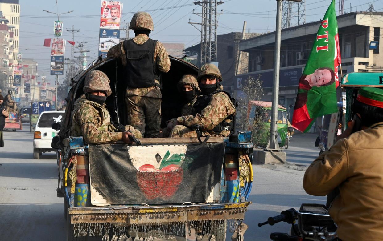 Pakistan Army patrols a road in Peshawar on Wednesday