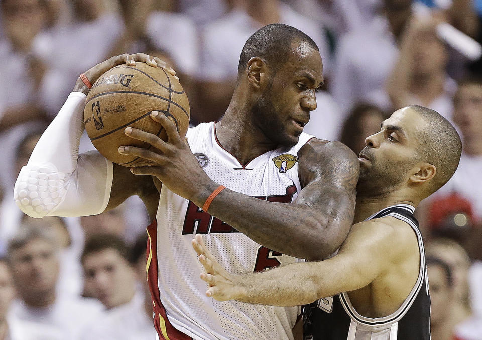 FILE - In this June 18, 2013 file photo, San Antonio Spurs point guard Tony Parker, right, and Miami Heat small forward LeBron James collide during the second half of Game 6 of the NBA Finals in Miami. A rematch of last year's thrilling NBA Finals finish is possible, but the Spurs and Heat would have to get through tough paths to get there. (AP Photo/Lynne Sladky, File)