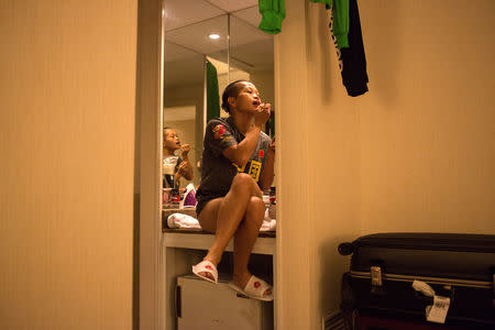 Huang Wensi applies makeup in her hotel room before the match in Taipei, Taiwan, September 26, 2018. REUTERS/Yue Wu