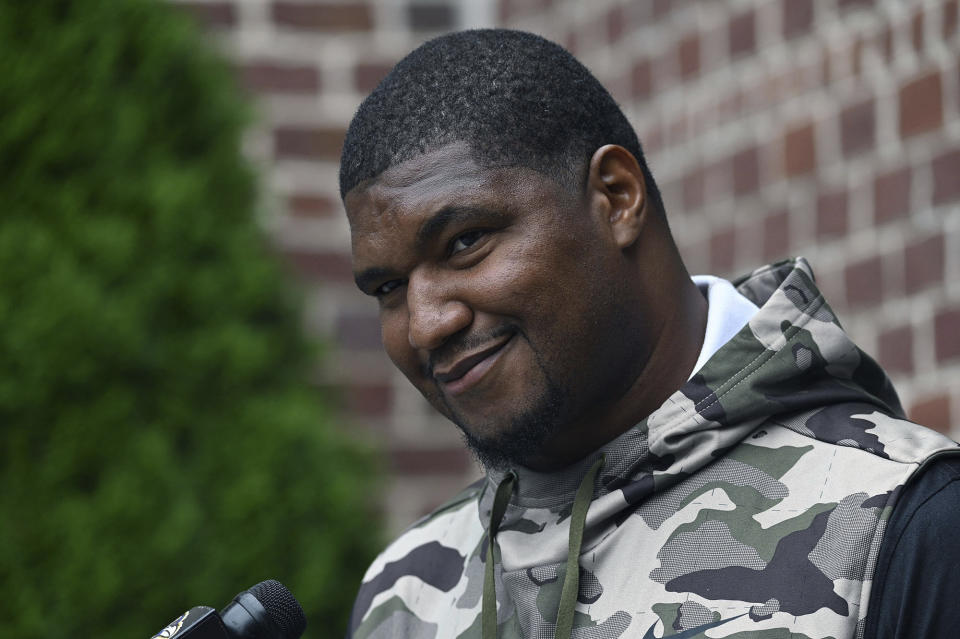 Baltimore Ravens' Calais Campbell speaks with media members at NFL football training camp in Owings Mills, Md., Tuesday, July 26, 2022. (Kenneth K. Lam/The Baltimore Sun via AP)