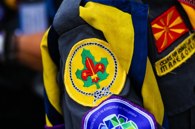 A scout from Macedonia shows the patches on his uniform ahead of the K-pop finale. Photo by Thomas Maresca/UPI