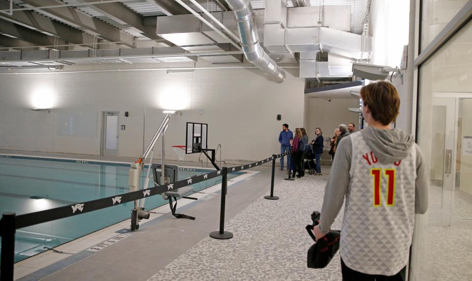 People tour the pool area of the Young Family Athletic Center during a grand opening Monday in Norman.