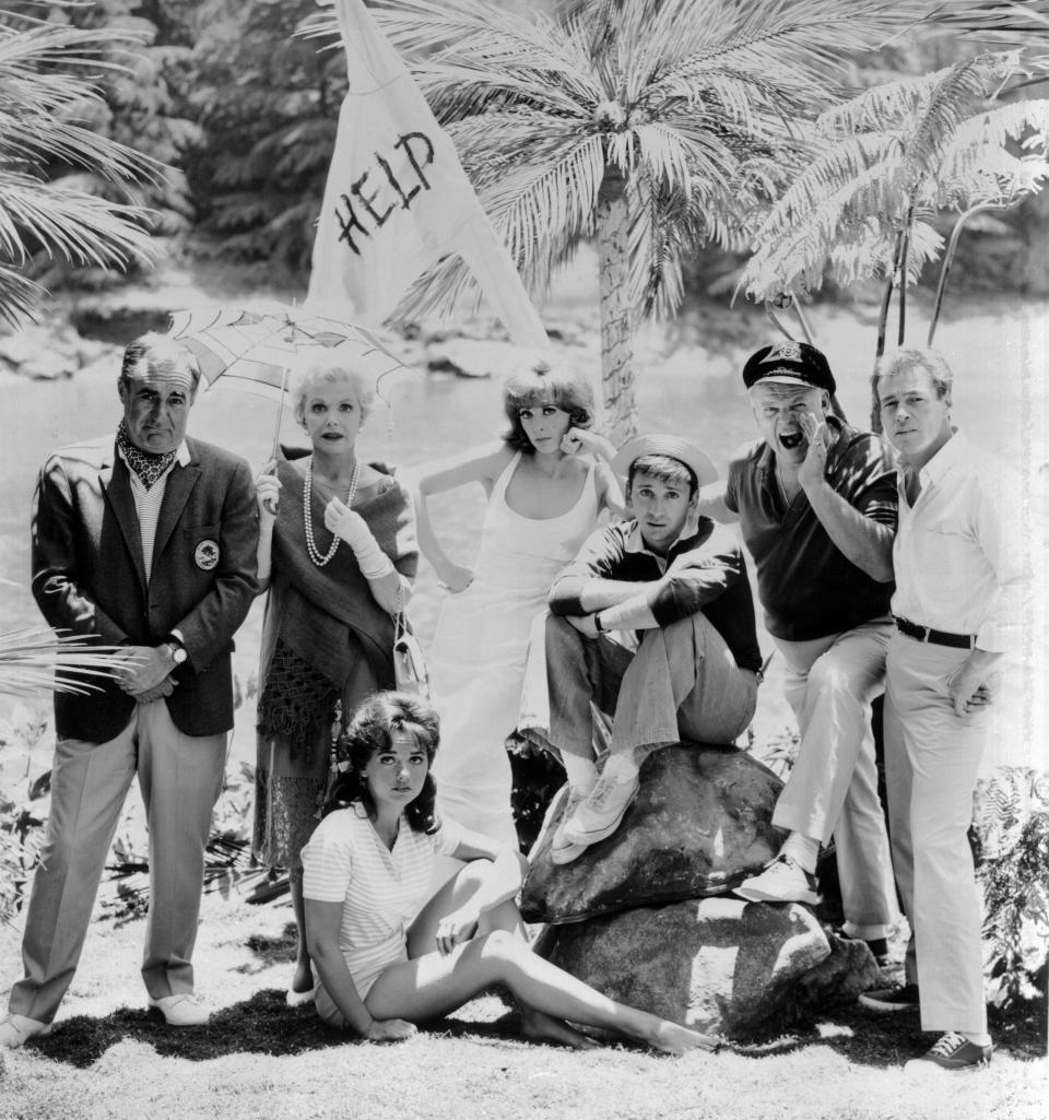 Dawn Wells, seated, poses with fellow "Gilligan's Island" cast members Jim Backus, standing left, Natalie Schafer, Tina Louise, Bob Denver, Alan Hale Jr. and Russell Johnson in a photo from the 1960s CBS sitcom.