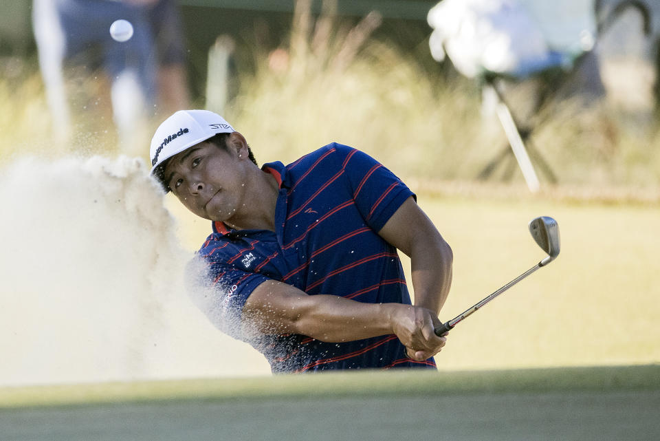 Kurt Kitayama hits out of a bunker on the 17th green during the final round of the CJ Cup golf tournament Sunday, Oct. 23, 2022, in Ridgeland, S.C. (AP Photo/Stephen B. Morton)