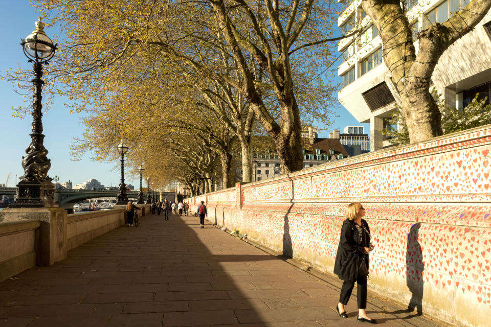  People pay tributes by painting hearts and signatures on the wall as the city re-opens after COVID cases subside.
The National COVID Memorial Wall is established along the banks of River Thames, outside St. Thomas' Hospital in London to commemorate NHS staff and patients who have given their lives over the course of the Pandemic. (Photo by Belinda Jiao / SOPA Images/Sipa USA) 