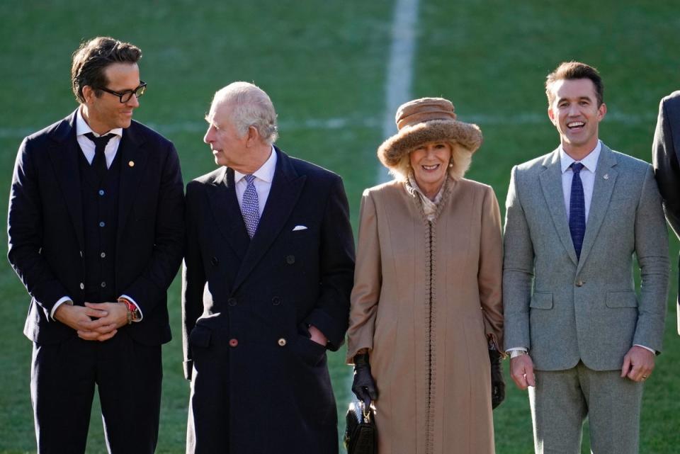 King Charles III and Camilla, Queen Consort talk to Co-Owners Wrexham AFC Ryan Reynolds (L) and Rob McElhenney (R) during their visit to Wrexham AFC on December 09, 2022 (Getty Images)