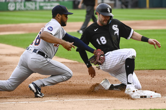 Chicago White Sox's AJ Pollock (18) beats the tag by Detroit Tigers third baseman Jeimer Candelario (46), advancing on a single by Yoan Moncada during the first inning of a baseball game, Saturday, Aug. 13, 2022, in Chicago. (AP Photo/Matt Marton)