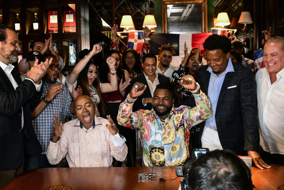 Former Boston Red Sox player David Ortiz, center, celebrates his election to the baseball hall of fame with his father Leo Ortiz, left, MLB Hall of Fame player Pedro Martinez, second right, and Fernando Cuzza, right, moments after receiving the news in Santo Domingo, Dominican Republic, Tuesday, Jan. 25, 2022. (AP Photo/Manolito Jimenez)