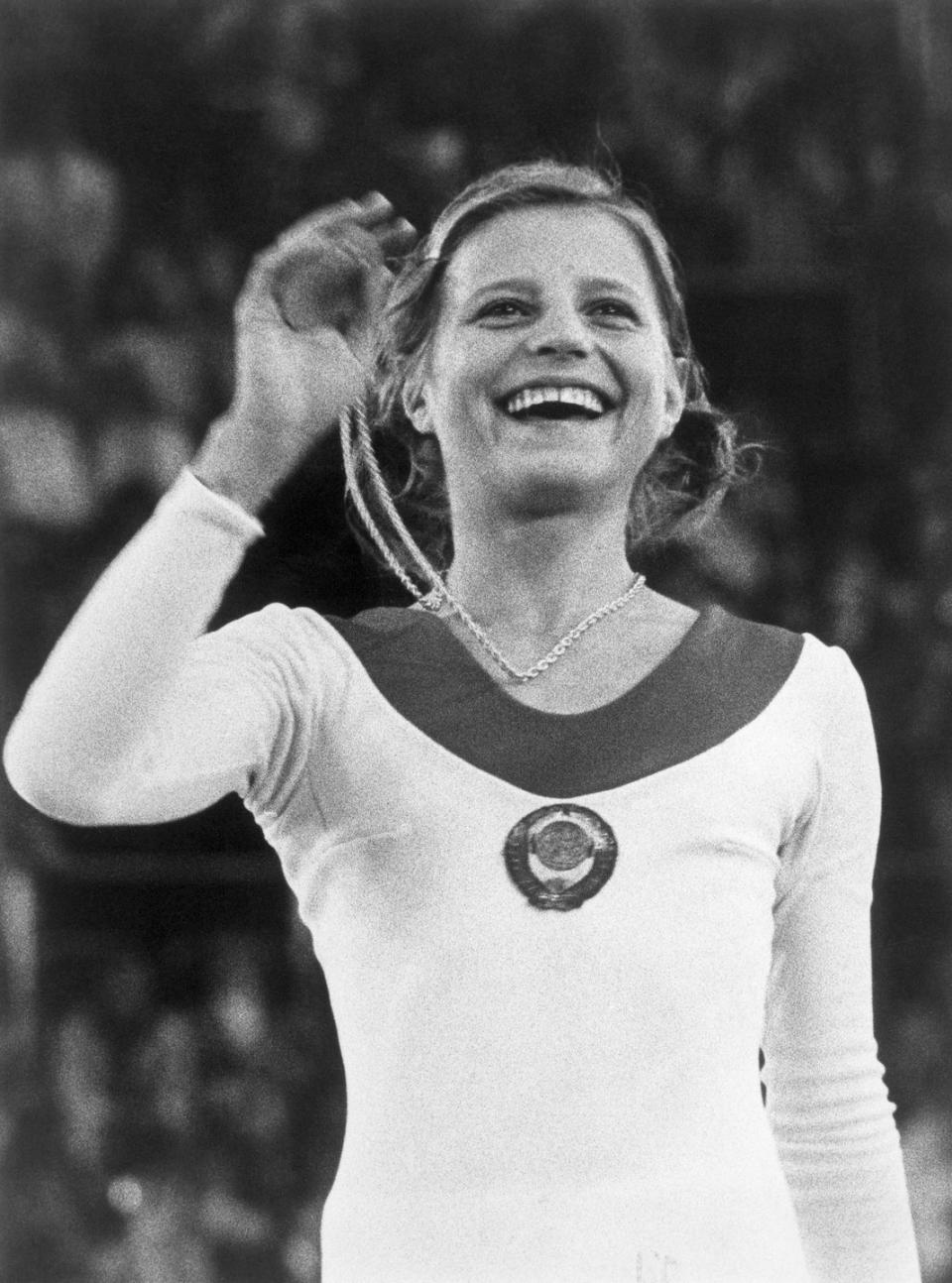 gymnast olga korbut holding gold medal, 1972