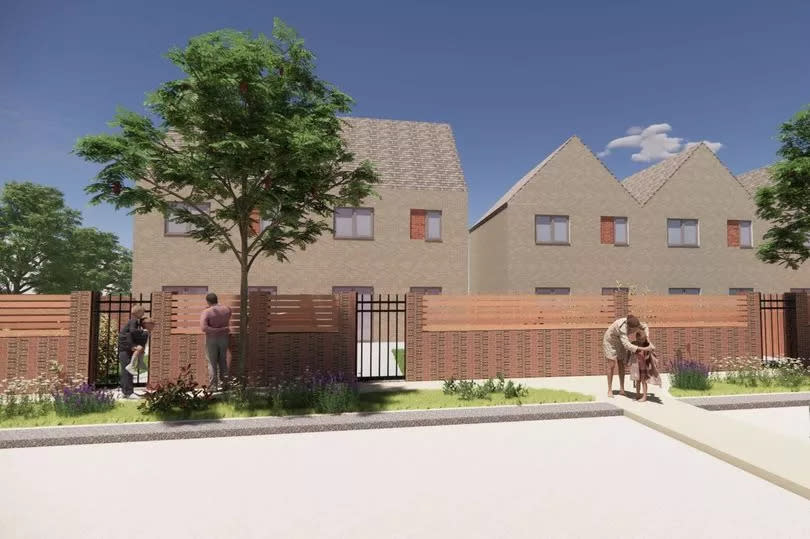 Lower-down view of the buildings, showing a front wall made up of different colours of red brick, with a wood fence above and iron-style gates. CGI renders of people and cars appear for scale