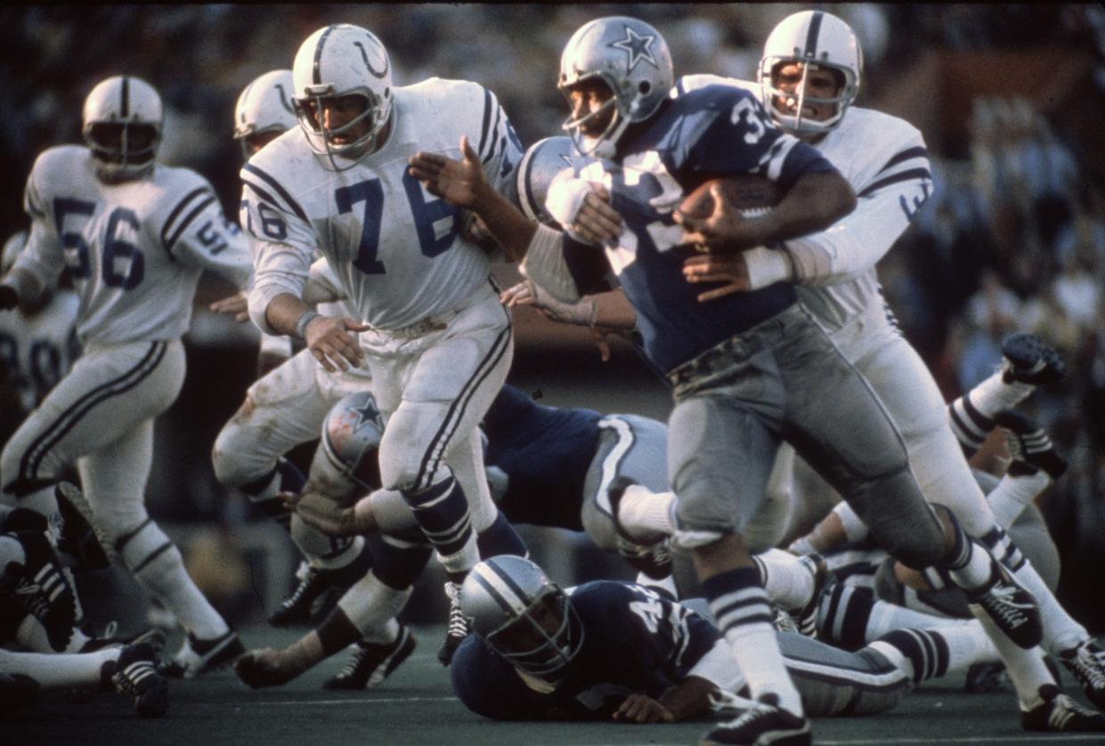 Mike Curtis #32 of the Baltimore Colts tackles Duane Thomas #33 of the Dallas Cowboys during Super Bowl V on January 17, 1971 at the Orange Bowl in Miami, Florida.