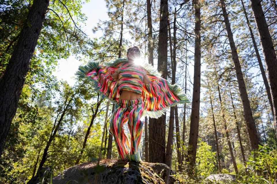 Fashion designer Schuyler Ellers models fringed pants and smoking jacket outside of his studio near Nevada City earlier this month. His clothing brand, Lord von Schmitt, is made from crochet blankets and throws.