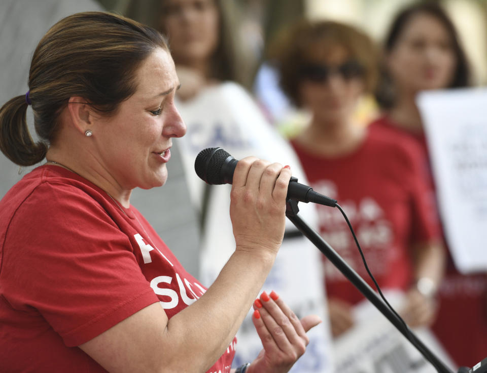 Jules Woodson, of Colorado Springs, Colo., speaks during a rally outside the Southern Baptist Convention's annual meeting Tuesday, June 11, 2019, in Birmingham, Ala. First-time attendee Woodson spoke through tears as she described being abused sexually by a Southern Baptist minister. (AP Photo/Julie Bennett)