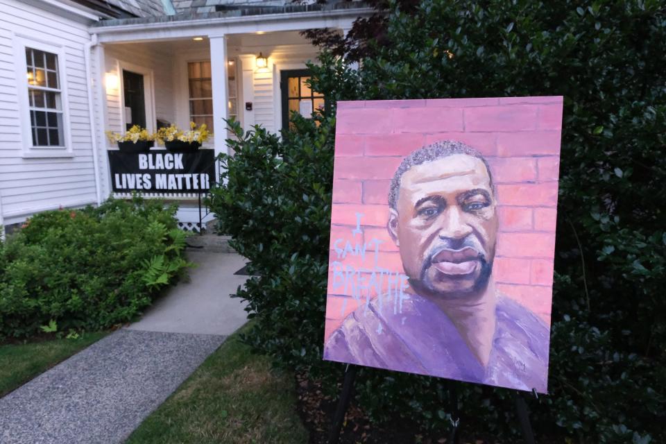 A portrait of George Floyd is on display outside the Unitarian Universalist Church where the North Shore Solidarity March: We Still Can't Breathe concluded in Marblehead, Mass., on July 31, 2020.