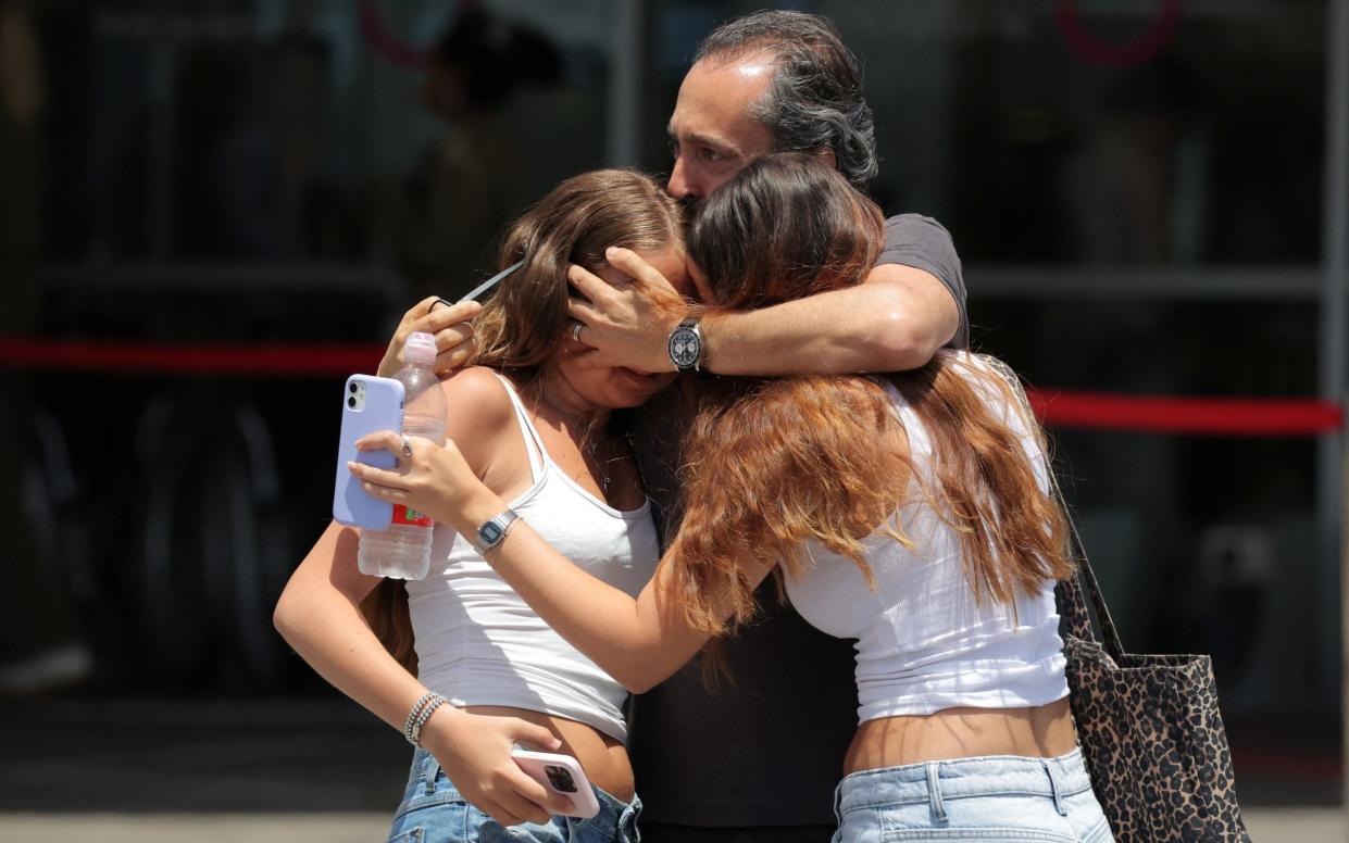 Family members of hostages walk to the health cente where those who have been freed are receiving medical attention