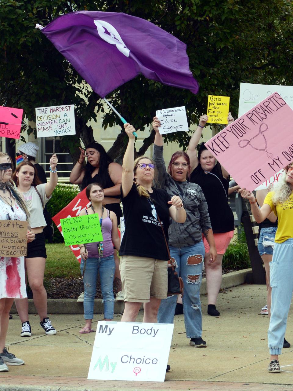 Kristine Fowler-Geis waves a flag during a protest against the U.S. Supreme Court's overturn of Roe vs. Wade on Wednesday in front of the Muskingum County Courthouse in downtown Zanesville. An event posting through social media website Facebook attracted dozens of activists.